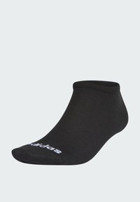 Schwarze Knöchelsocke mit einem geriffelten Muster, die ein weißes Logo an der Seite hat. Entworfen für einen engen Sitz mit einem flachen Profil.