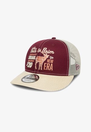 Maroon snapback cap with a beige corduroy visor and mesh sides. Features embroidered graphics of a deer and text promoting steak dinners.