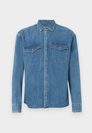 Helesinine teksariiet, millel on pikad varrukad, terav krae, kaks esistooti, millel on klapp, ja hõbedased nupud.