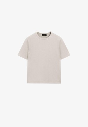 Lysegrå bomulds t-shirt med korte ærmer, rund halsudskæring og afslappet pasform. Har minimal syning og ingen synlige mønstre eller accenter.