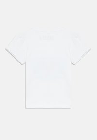 Λευκό κοντομάνικο μπλουζάκι με στρογγυλή λαιμόκοψη, με πιέτες στα μανίκια και διακριτικό λογότυπο στο πίσω μέρος. Απαλή βαμβακερή ύφανση.