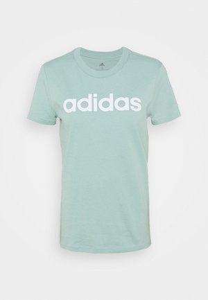 Vihreä puuvillapaita, jossa on valkoinen "adidas"-logo rinnassa. Klassinen pyöreä kaula-aukko ja lyhyet hihat, pehmeä pinta.