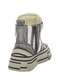 White and gray striped ankle boot with a textured finish, side zipper, and a thick rubber sole featuring black stripes.
