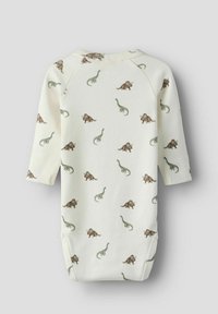 Wit katoenen romper met lange mouwen, voorzien van een gedrukt patroon van groene en bruine dinosaurussen. Zachte textuur, ronde halslijn, drukknoopsluiting aan de onderkant.