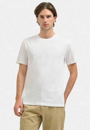 Hvid bomulds t-shirt med rund halsudskæring og korte ærmer, med et enkelt design og en afslappet pasform.
