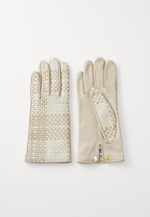 Beige bőrvédő kesztyű, elülső részén szőtt mintázattal. Figyelemre méltó részletei közé tartozik egy oldalsó nyílás és aranyszínű díszítések.