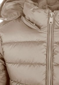 Kadar pogledu na bež prešani puffer jaknu s prednjim patentnim zatvaračem i podstavljenim ovratnikom.