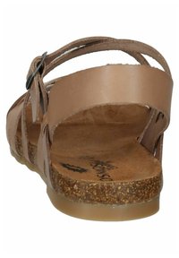 Brown leather sandal with a cork footbed, featuring multiple straps and a buckle closure. Flat sole with a textured surface.