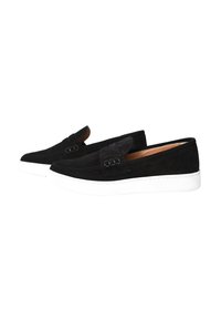 Scarpe slip-on nere in suede con suola piatta bianca, caratterizzate da accenti decorativi e cuciture dettagliate lungo i bordi.