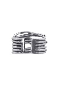 Silver metal ring featuring a twisted design with parallel grooves, creating a textured surface and unique, modern appearance.
