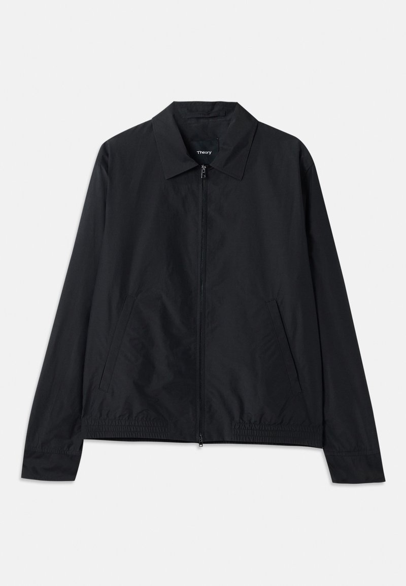 Black lightweight jacket with a collared neck, front zip closure, side pockets, and elasticized waistband. Smooth, matte texture.