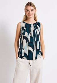 Top senza maniche con scollo a giro, caratterizzato da un motivo astratto in turchese, crema e nero; tessuto leggero con dettagli a plissettatura.