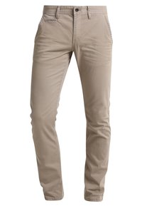 Pantalons slim-fit en coton beige avec un devant plat, des passants de ceinture et une fermeture éclair. Comprend des poches latérales et des détails de couture minimalistes.