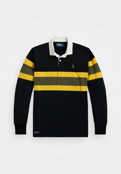 Πολυεστερική μπλούζα με μακριά μανίκια σε ναυτικό χρώμα με άσπρο γιακά και κίτρινες-πράσινες οριζόντιες ρίγες. Διαθέτει λογότυπο στο αριστερό στήθος και ριμπ μανσέτες.