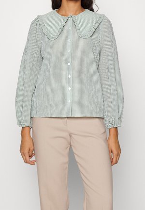 Green checkered blouse with a large ruffled collar, long puff sleeves, and button front; fabric appears lightweight and textured.