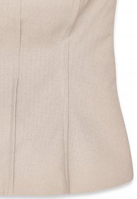 Beige tailored vest with a fitted design, textured fabric, and subtle diagonal pattern, featuring structured seams and a flared bottom.