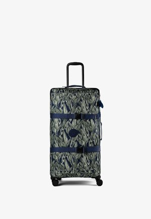 Tall wheeled suitcase with extended handle and patterned fabric in shades of green and navy, secured by two blue straps with buckles.