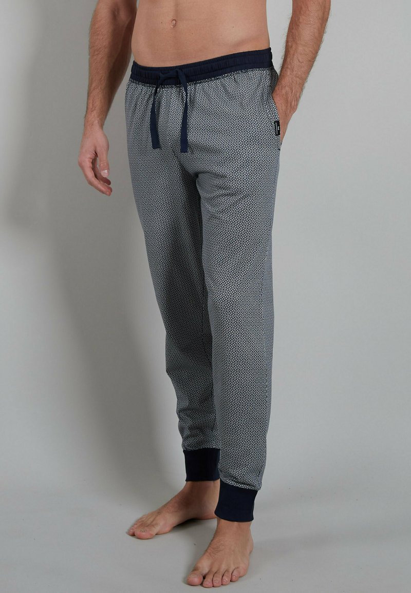 Grey patterned lounge pants with a drawstring elastic waistband and navy blue cuffs. Lightweight fabric with a soft texture.