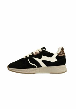 Black and white athletic shoe with a speckled beige sole, suede upper, leopard print accents, and cream laces. Features a curvy design.