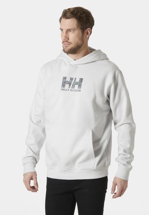Witte hoodie van zachte stof, met een voorzak, geribbelde manchetten en een camouflage logo met de tekst "HELY HANSEN" op de borst.