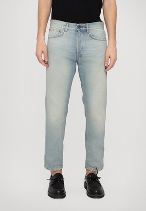 Light blue denim jeans with a straight cut, faded texture, five-pocket design, and a button closure at the waist, worn with black shoes.