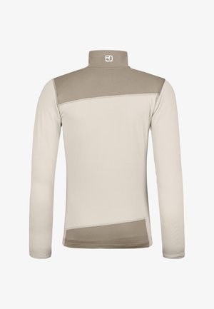 Long-sleeve shirt in light beige with a high collar. Features a darker beige panel across the shoulders and textured fabric details.