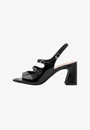Black patent leather heeled sandals with open toe, three adjustable straps, and a chunky heel. Smooth texture with buckled accents.