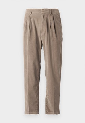 Beige corduroy trousers with a relaxed fit, featuring pleats, a button closure, and side pockets, textured surface, and tapered leg design.