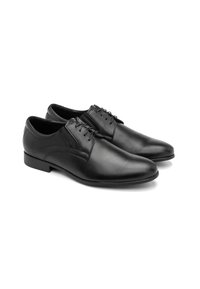 Scarpe eleganti in pelle nera con finitura liscia, punta affusolata e sei asole per lacci. Presentano sottili accenti di cucitura sui lati.