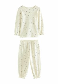 Light cream, long-sleeve top and matching pants, both with small black polka dots. Soft cotton material with elastic cuffs and waistband.