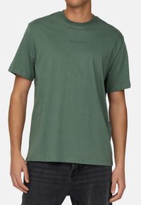 Green cotton crew neck t-shirt with short sleeves, featuring tonal embroidered "ONLY & SONS" logo on the chest, relaxed fit.