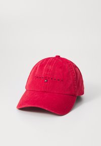 Red cotton baseball cap with a curved brim, featuring "TOMMY JEANS" embroidered in black. Includes a small logo in blue, white, and red.