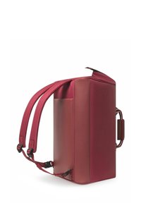 Sac à dos en cuir rouge avec deux bretelles réglables, une poche latérale et un dessus zippé. Le matériau a une finition texturée et une forme rectangulaire.