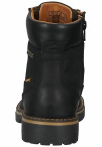 Black leather ankle boot with a smooth texture, featuring yellow accents, a side zipper, and a chunky rubber sole with visible tread patterns.