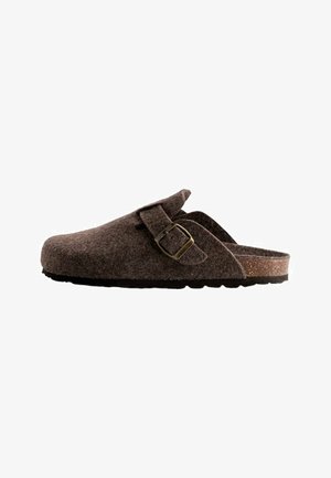 Brown felt clog with a leather strap and brass buckle. Features a rounded toe, textured surface, and a cork footbed with a rubber sole.