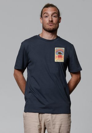 Navy blue short-sleeve t-shirt made of cotton with a printed design featuring a chocolate bar and colorful background.