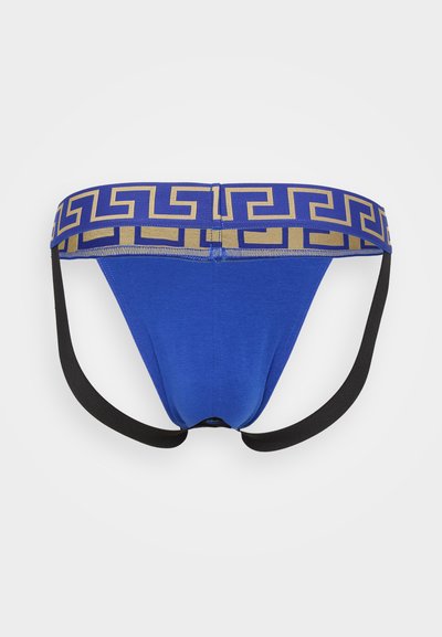 Blaue Stofftanga mit einem goldenen geometrischen Muster am Bund, mit schwarzen Trägern, die von den Seiten ausgehen. Glatte Textur.
