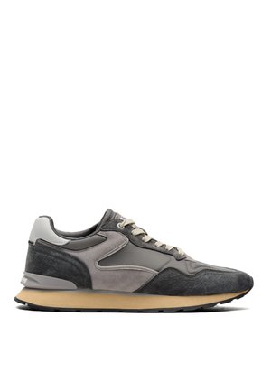 Gray and black athletic sneaker with beige sole, white laces, and padded ankle collar shown in left side profile on white background.