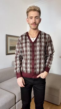Cardigan de malha em padrão xadrez bordeaux e branco, apresenta gola em V, fecho frontal com botões e punhos canelados. Tecido texturizado.