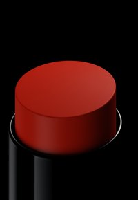 Cappuccio cilindrico rosso su una base cilindrica nera, superficie liscia, finitura opaca, posizionato su uno sfondo nero.