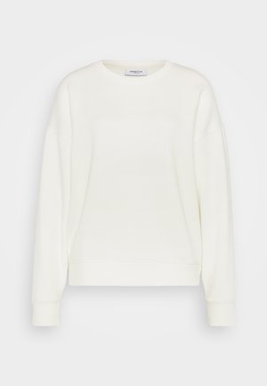 Sweatshirt couleur crème avec un col rond, des épaules tombantes longues, des poignets côtelés et un ourlet droit. Fabriqué en tissu doux et lisse.