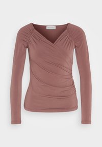 Langärmliges, wickelartiges Oberteil in Mauve, mit gerafften Details an den Schultern und an der Seite, aus einem weichen, dehnbaren Stoff.