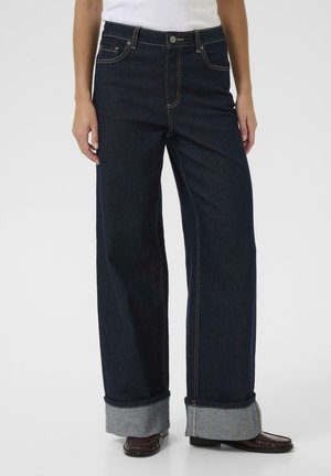 Wide-leg dark denim jeans with a high waist, featuring gold stitching, a button closure, and turned-up cuffs with a grey inner fabric.