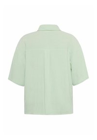 Lühikeste varrukatega, helesinine linane shirt, millel on krae ja seljapaneel. Hästi istuv ja pehme tekstuuriga kangas.
