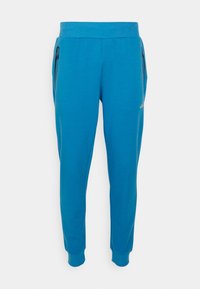 Modré joggingové kalhoty s žebrovanými lemy, elastickým pasem, dvěma bočními kapsami na zip a malým bílým logem na pravém stehně.