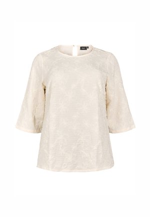 Blusa di colore crema con un motivo floreale testurizzato, scollo rotondo e maniche a lungo fino al gomito. Chiusura con zip sul retro, vestibilità leggermente rilassata.