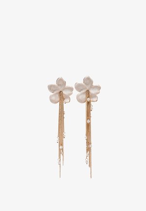Floral-shaped earrings with white petals and multiple gold chains adorned with small white beads hanging from each flower.