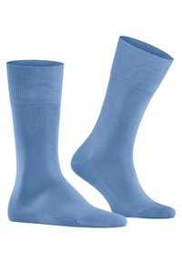 Calzini blu chiaro realizzati in tessuto liscio. Presentano un bordo a coste e una punta senza cuciture, offrendo un colore uniforme in tutto il calzino.