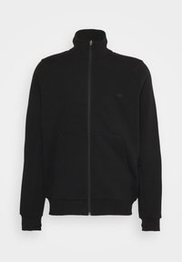 Sort zip-up sweatshirt med høj krave, forlommer og ribstrikkede manchetter. Har et diskret logo på venstre side. Blødt materiale.