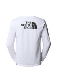 Witte lange mouwen shirt met zwart logo, voorzien van de tekst "THE NORTH FACE" en een gebogen ontwerp aan de achterkant. Glad katoenmateriaal.